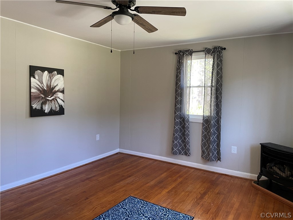 228 Beech Forest Road Kenbridge, VA 23944 - Photo 7 of 23 a view of empty room with wooden floor and fan