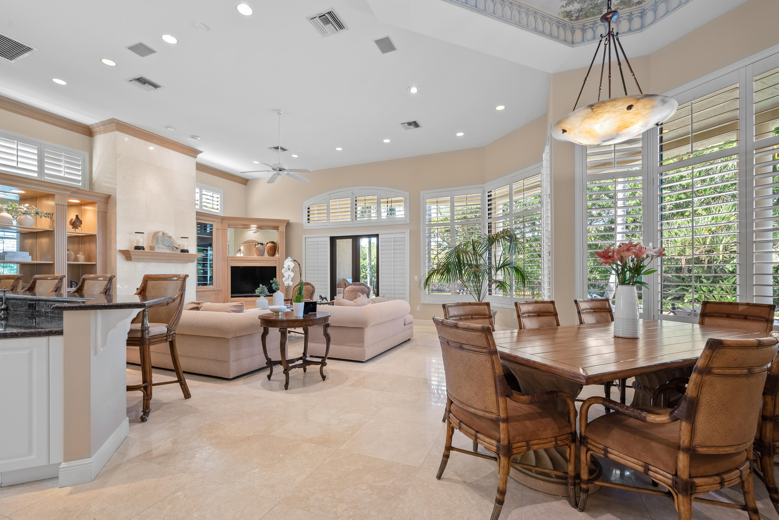 18800 Long Lake Drive Boca Raton, FL 33496 - Photo 18 of 60 a dining room with furniture a large window and a chandelier