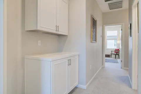 a view of a kitchen with white cabinets