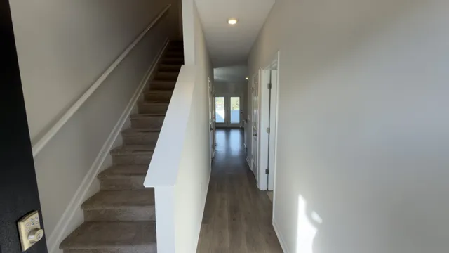 a view of entryway and hall with wooden floor