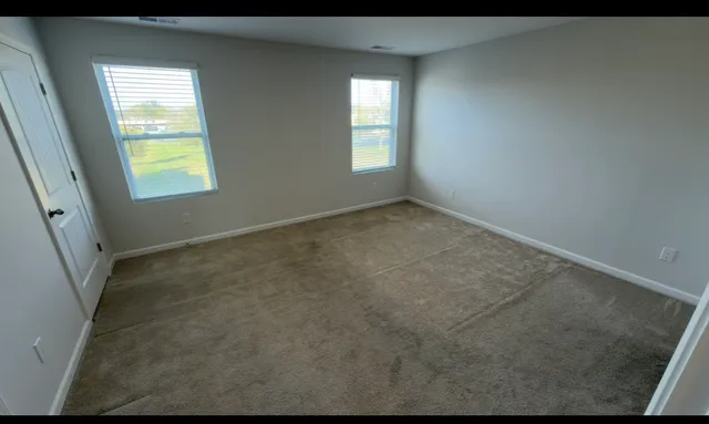 a view of an empty room and a window