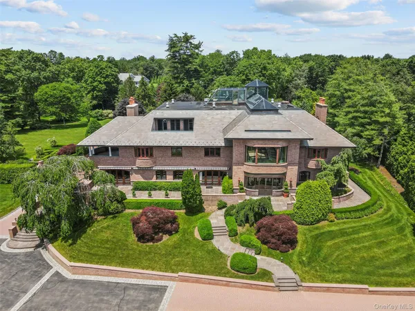 a aerial view of a house with yard and green space