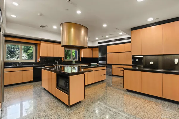 a dining room with furniture and a floor to ceiling window