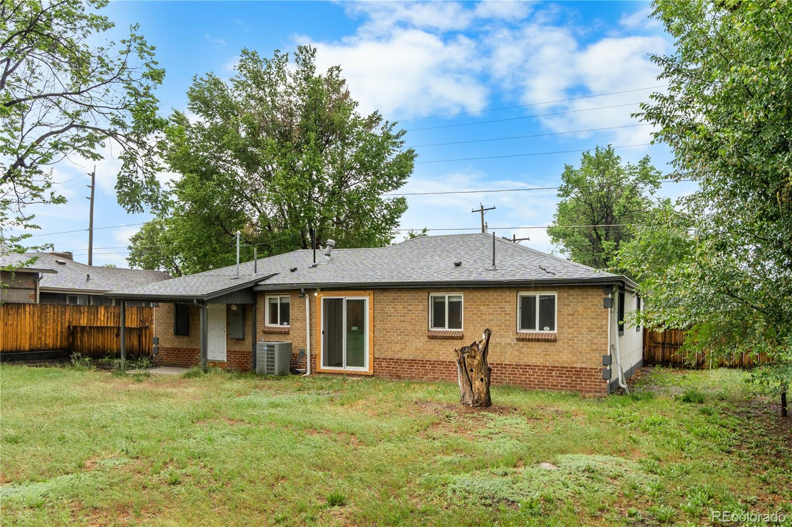 7010 West 44th Avenue Wheat Ridge, CO 80033 - Photo 29 of 31 a front view of a house with a garden