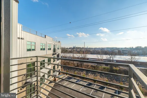 a view of a balcony next to a yard