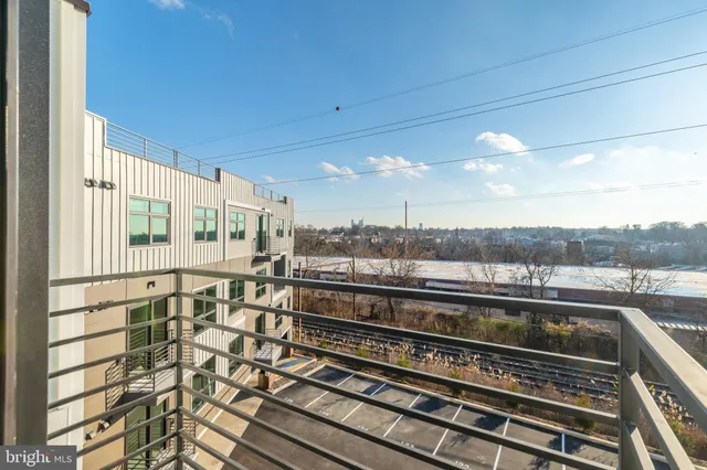 a view of a balcony next to a yard