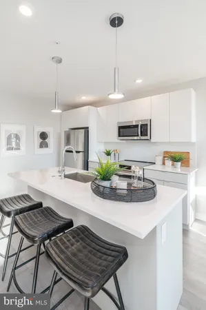 a kitchen with kitchen island a stove a table and chairs in it