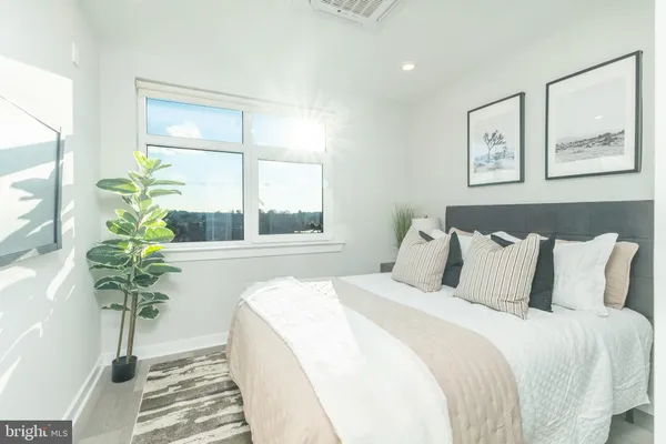 a large bed sitting in a bedroom next to a window