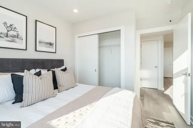 a bedroom with a bed and wall painting