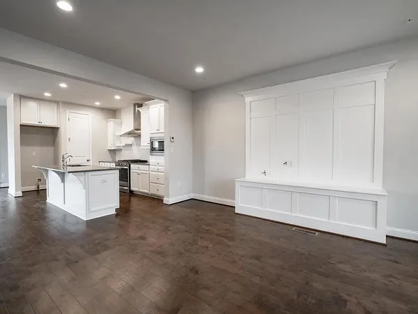 a view of kitchen with wooden cabinet