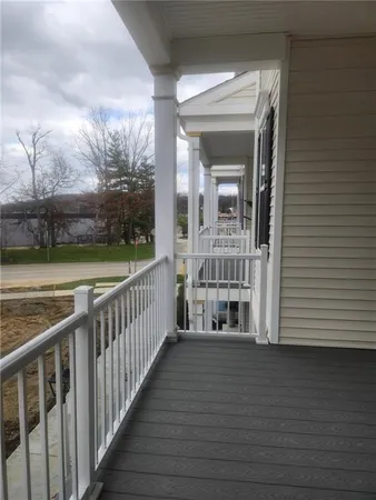 a view of a balcony with wooden floor