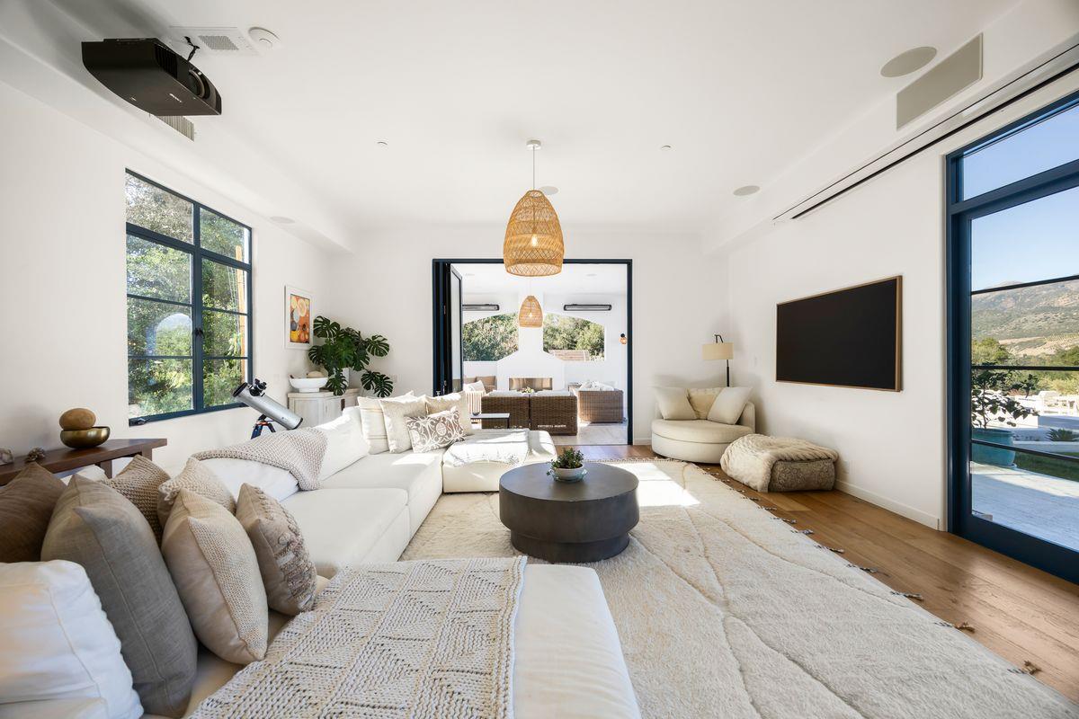 13202 Ojai Road Santa Paula, CA 93060 - Photo 13 of 50 a living room with furniture a flat screen tv and a large window