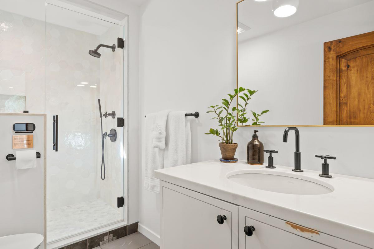 13202 Ojai Road Santa Paula, CA 93060 - Photo 17 of 50 a bathroom with a shower sink vanity and mirror