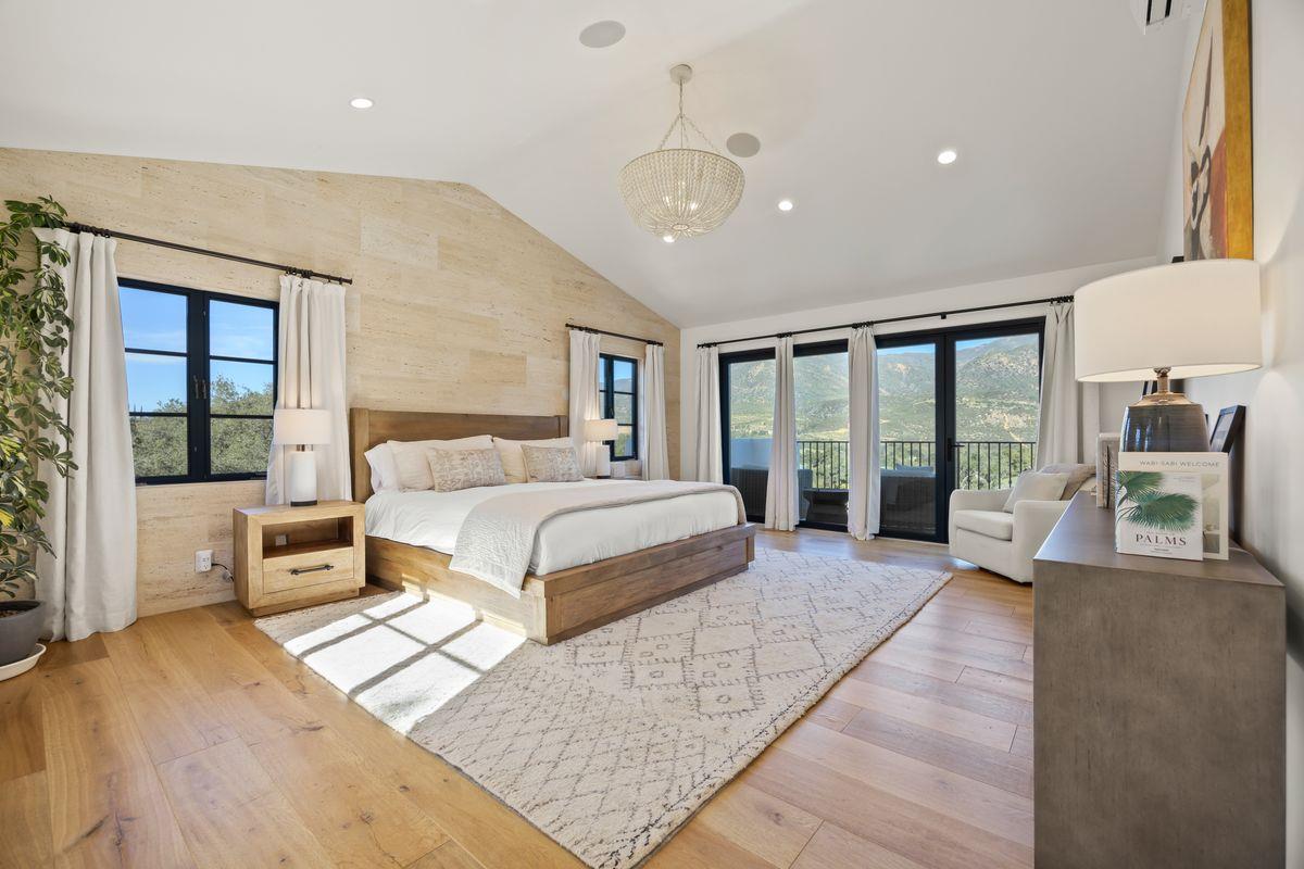 13202 Ojai Road Santa Paula, CA 93060 - Photo 20 of 50 a spacious bedroom with a large bed and a large window