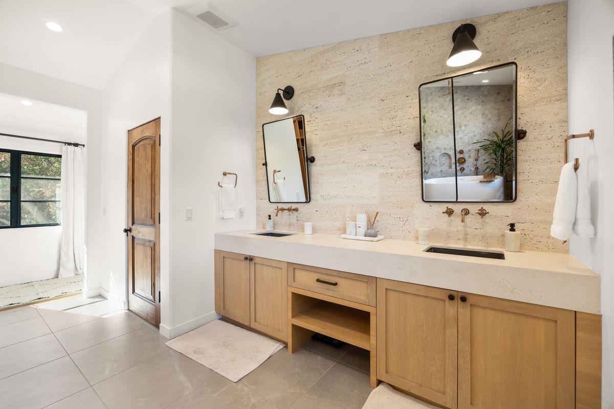 13202 Ojai Road Santa Paula, CA 93060 - Photo 24 of 50 a bathroom with a double vanity sink a mirror and a bathtub