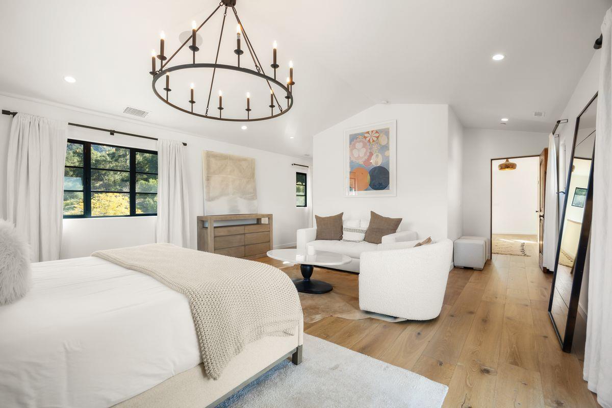 13202 Ojai Road Santa Paula, CA 93060 - Photo 29 of 50 a bedroom with a bed and a chandelier