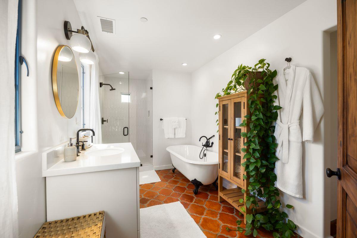 13202 Ojai Road Santa Paula, CA 93060 - Photo 30 of 50 a spacious bathroom with a toilet sink and mirror