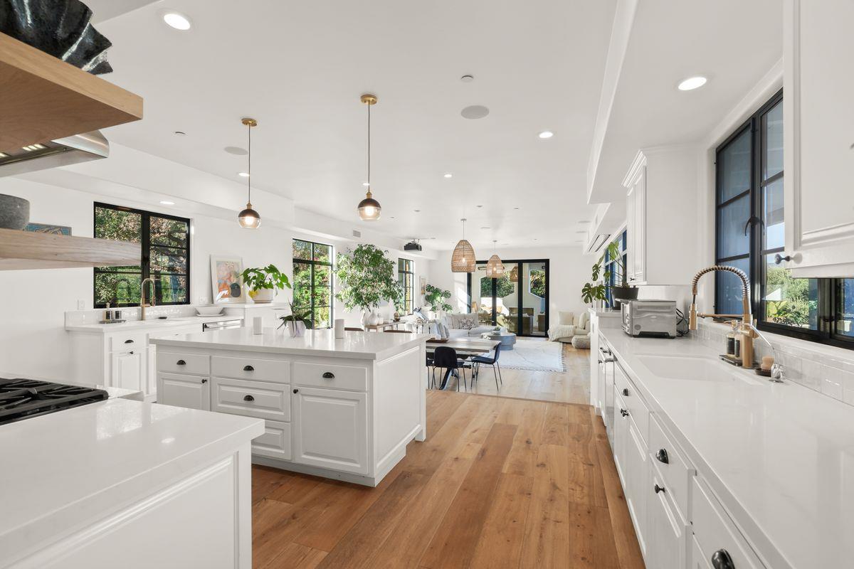 13202 Ojai Road Santa Paula, CA 93060 - Photo 8 of 50 a large kitchen with kitchen island white cabinets and stainless steel appliances