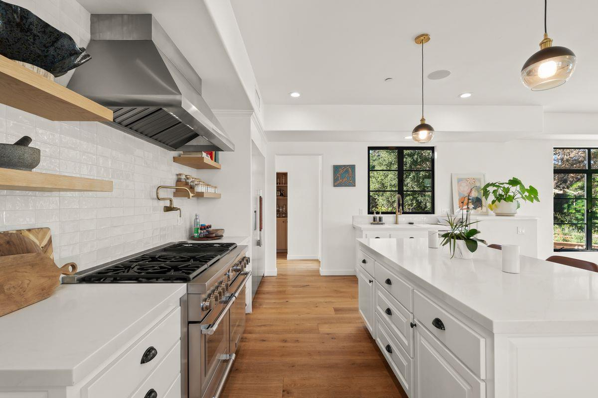 13202 Ojai Road Santa Paula, CA 93060 - Photo 9 of 50 a kitchen with granite countertop a sink stove and cabinets