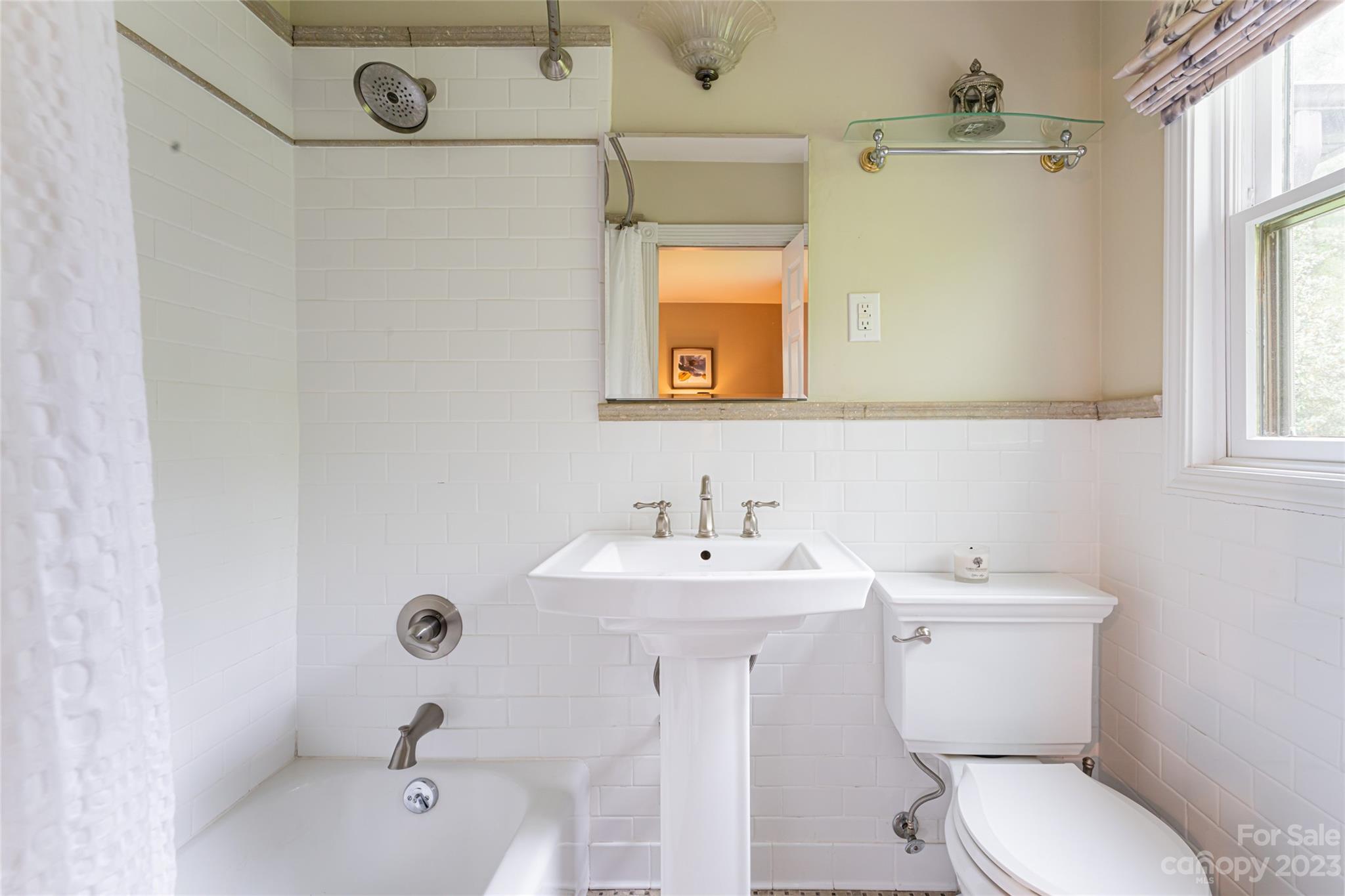 12 Club View Road Asheville, NC 28804 - Photo 23 of 47 a bathroom with a sink a toilet and mirror