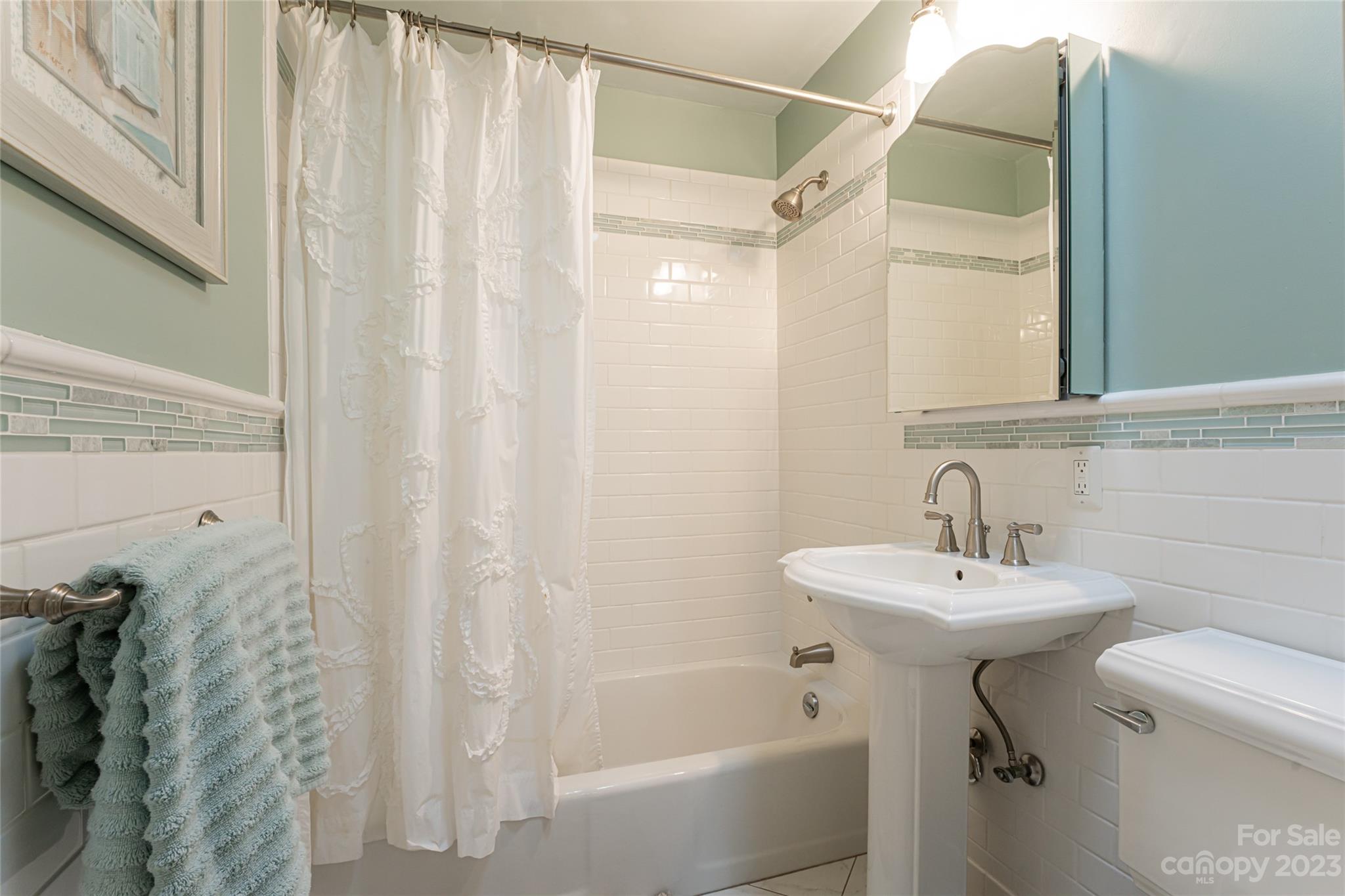 12 Club View Road Asheville, NC 28804 - Photo 25 of 47 a bathroom with a sink a toilet and shower