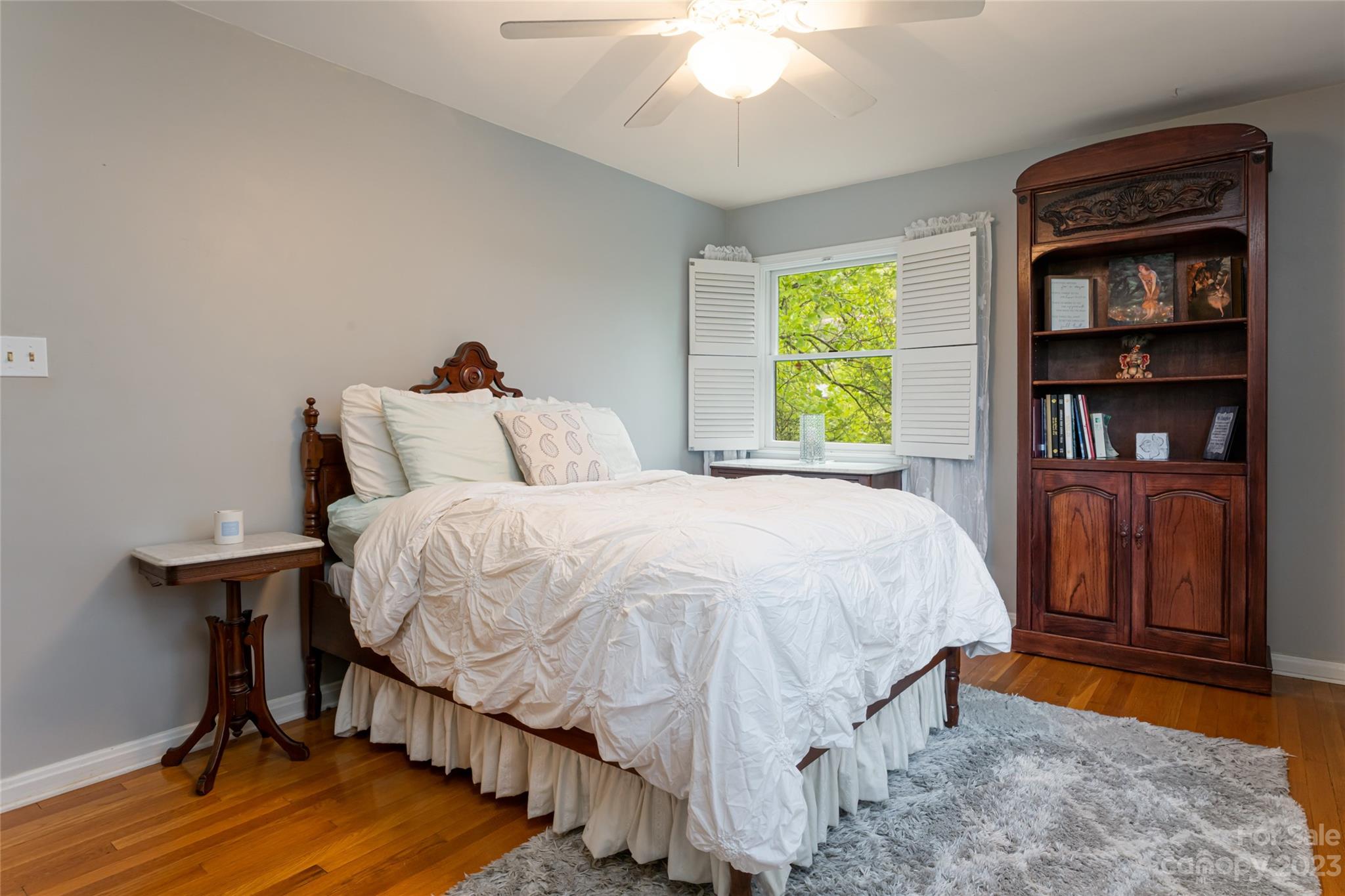 12 Club View Road Asheville, NC 28804 - Photo 27 of 47 a bedroom with a bed and a book shelf