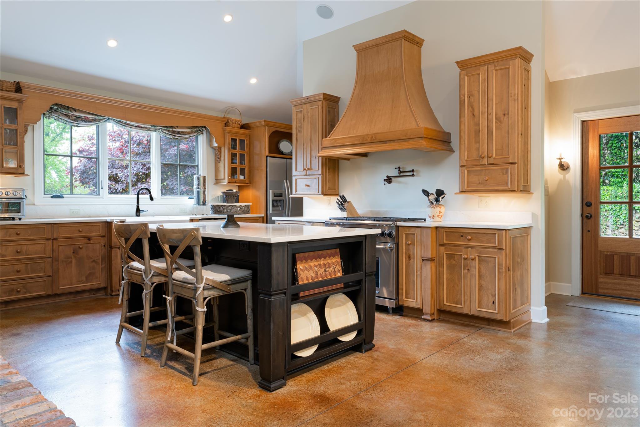 12 Club View Road Asheville, NC 28804 - Photo 9 of 47 a room with stainless steel appliances kitchen island granite countertop a stove a sink and a dining table with wooden cabinet