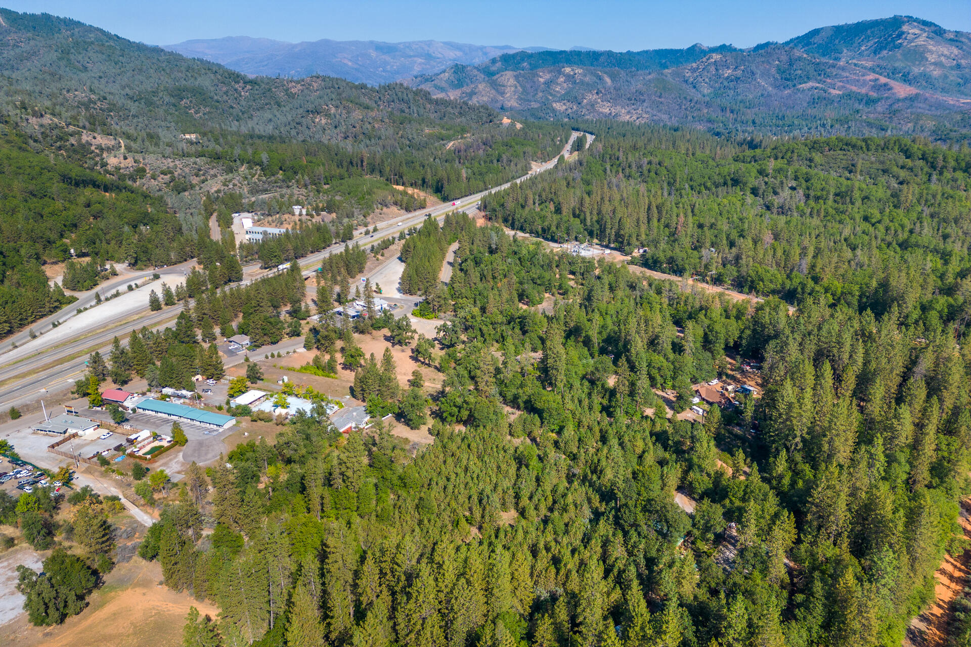 17 Acres In Lakehead Lakehead, CA 96051 - Photo 10 of 25 a view of a forest with a lush green hillside