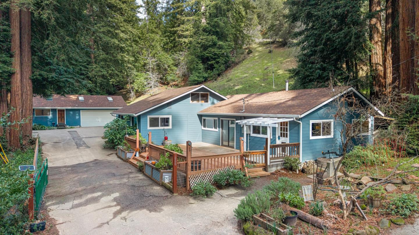 a view of house with a yard and potted plants