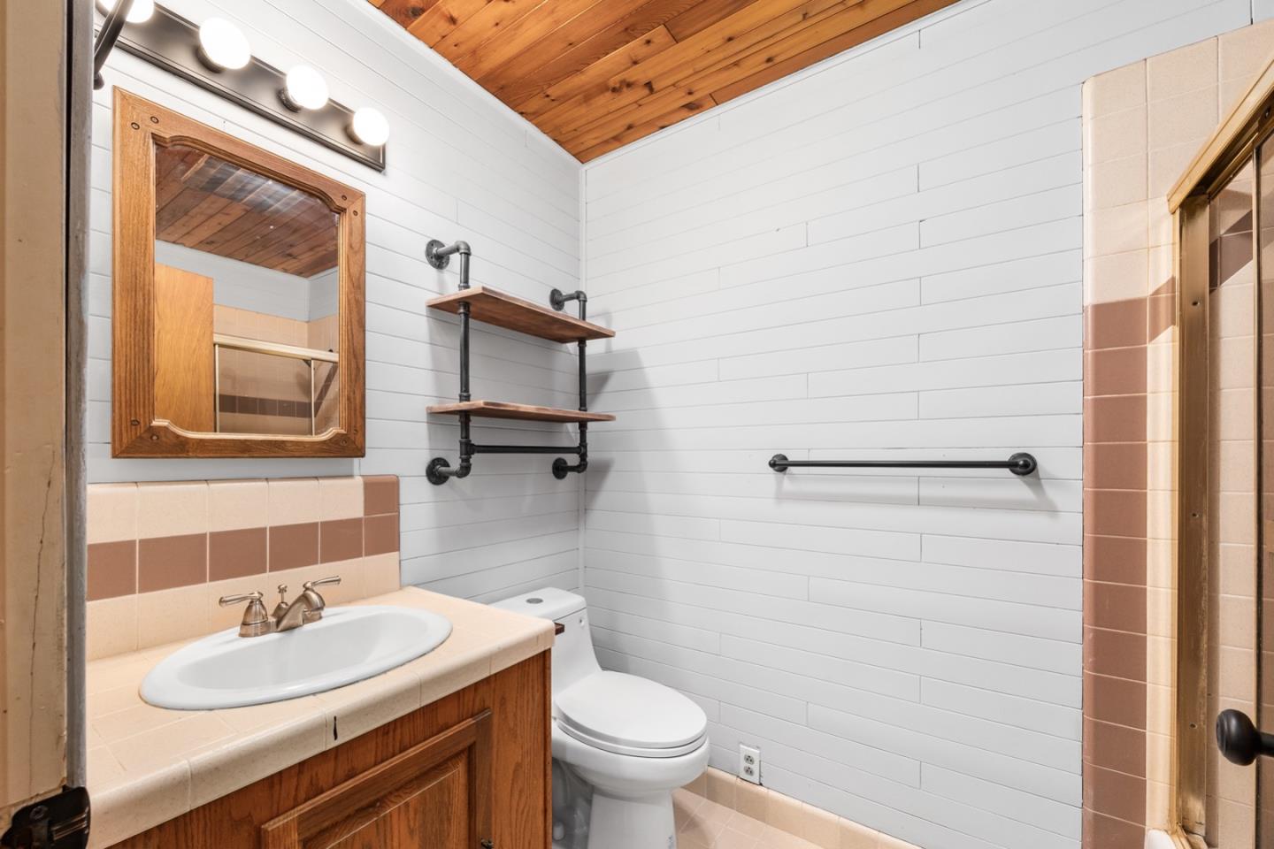 1000 Harmon Gulch Road Boulder Creek, CA 95006 - Photo 19 of 44 a bathroom with a sink a toilet and shower curtain