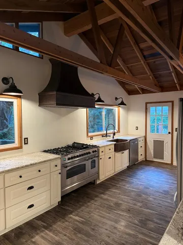 a kitchen with a stove window and wooden cabinets