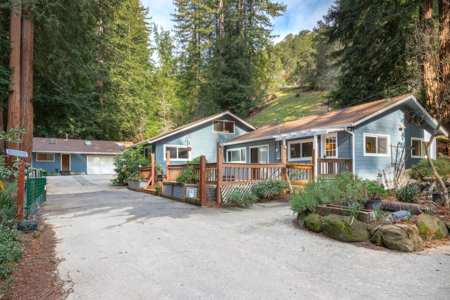 1000 Harmon Gulch Road Boulder Creek, CA 95006 - Photo 40 of 44 a front view of a house with a garden and trees