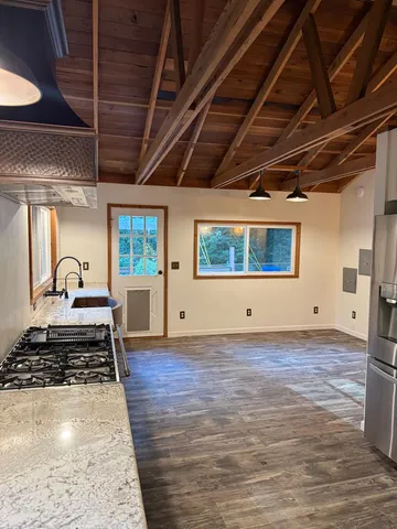 a view of a room with wooden floor