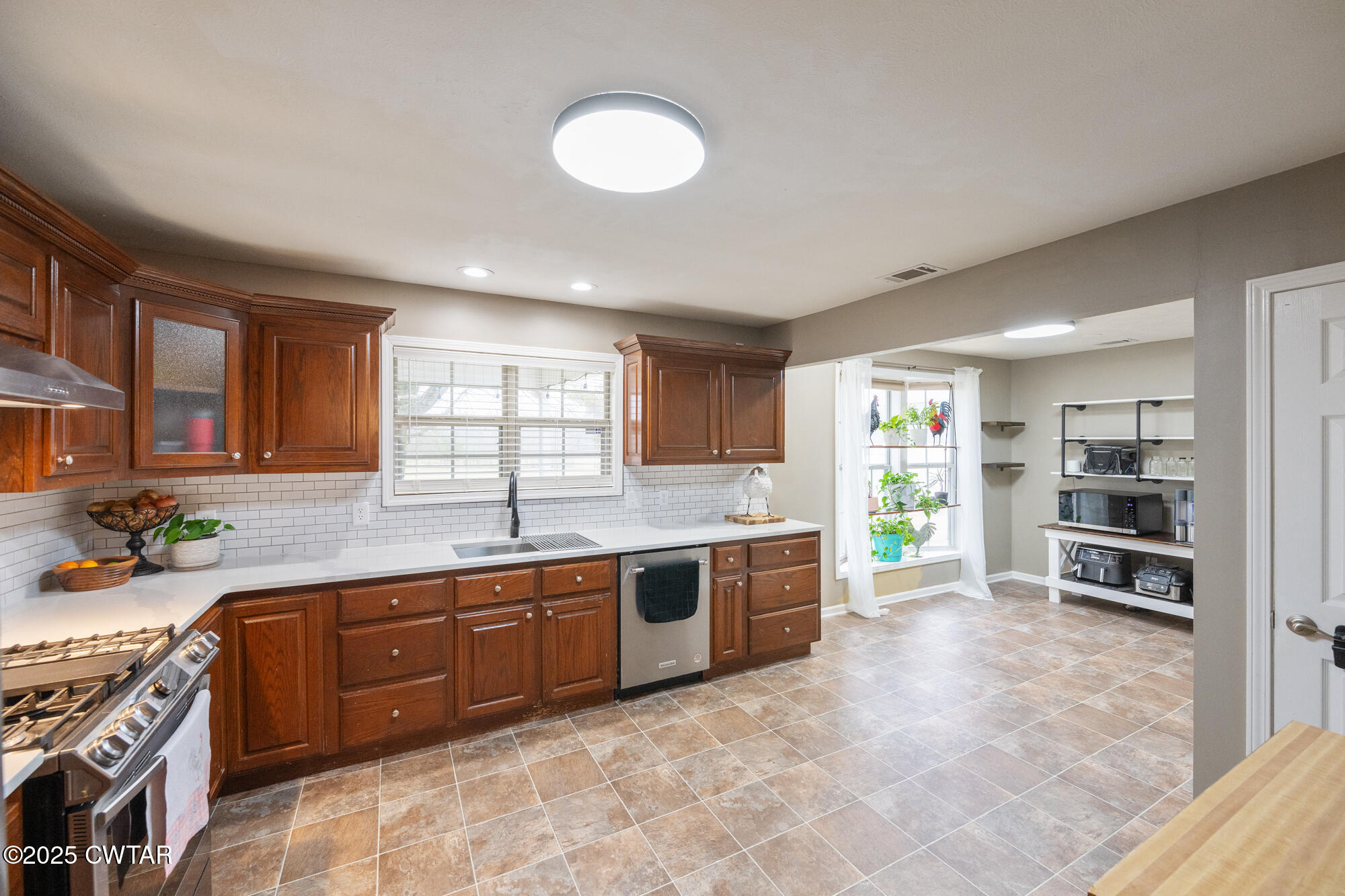 2250 Crucifer Road Huron, TN 38345 - Photo 12 of 32 a large kitchen with stainless steel appliances granite countertop a stove and a sink