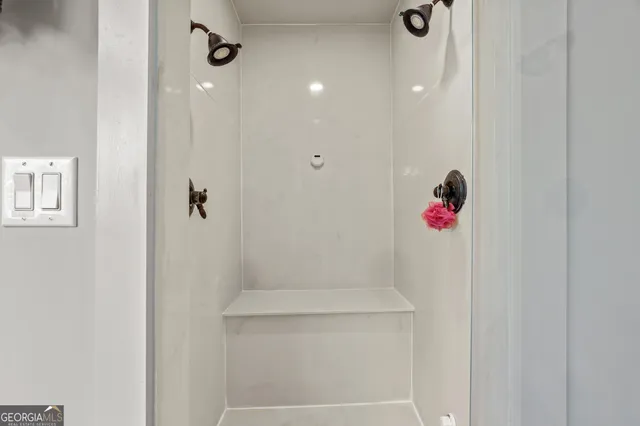 a bedroom with two beds and a window