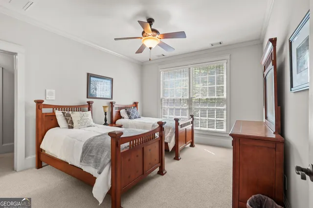 an aerial view of residential houses with outdoor space and trees all around