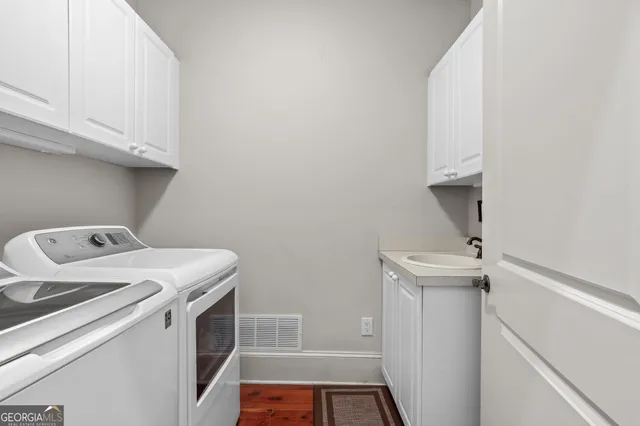 a view of a big house with a big yard and potted plants