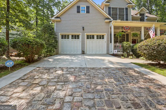 a front view of a house with a yard table and chairs