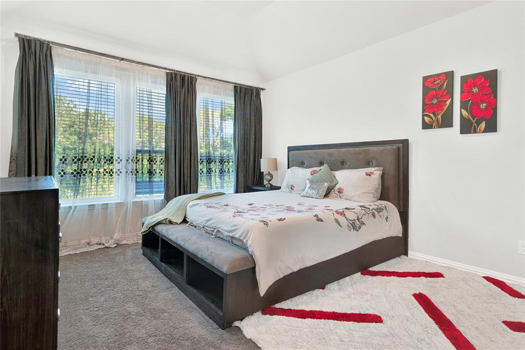 3712 Maroon Creek Road Aubrey, TX 76227 - Photo 11 of 21 a bedroom with a bed and a large window