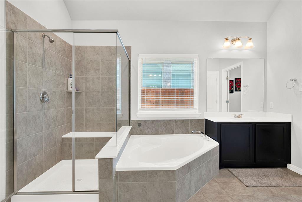 3712 Maroon Creek Road Aubrey, TX 76227 - Photo 13 of 21 a bathroom with a bathtub and a sink