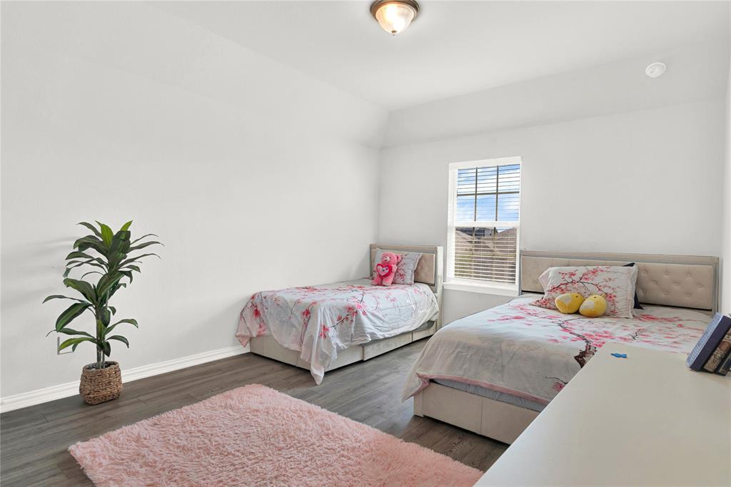 3712 Maroon Creek Road Aubrey, TX 76227 - Photo 14 of 21 a bedroom with two beds and potted plant