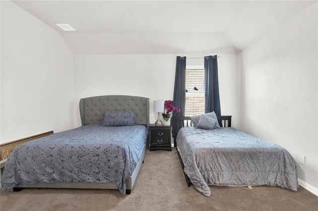 a bedroom with bed and a window