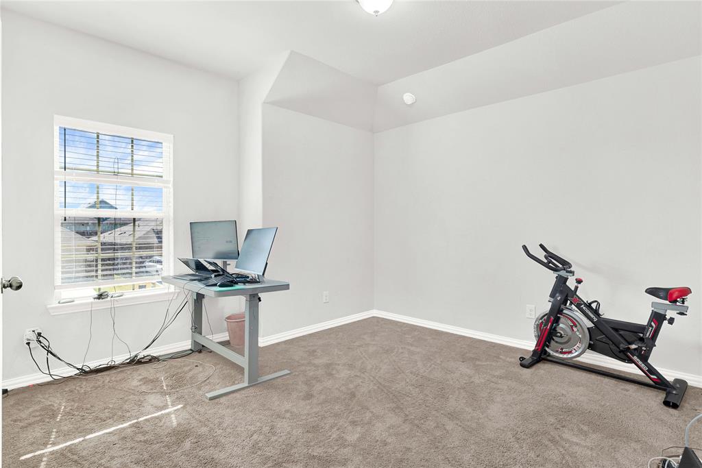 3712 Maroon Creek Road Aubrey, TX 76227 - Photo 17 of 21 a view of a room with gym equipment and windows