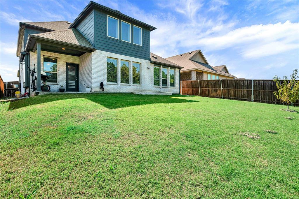3712 Maroon Creek Road Aubrey, TX 76227 - Photo 19 of 21 a view of a brick house with a big yard and large trees