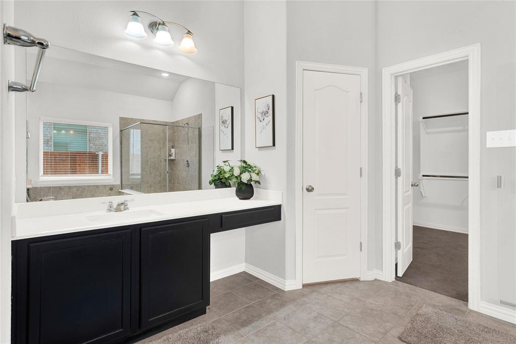 3712 Maroon Creek Road Aubrey, TX 76227 - Photo 9 of 21 a bathroom with a double vanity sink and mirror
