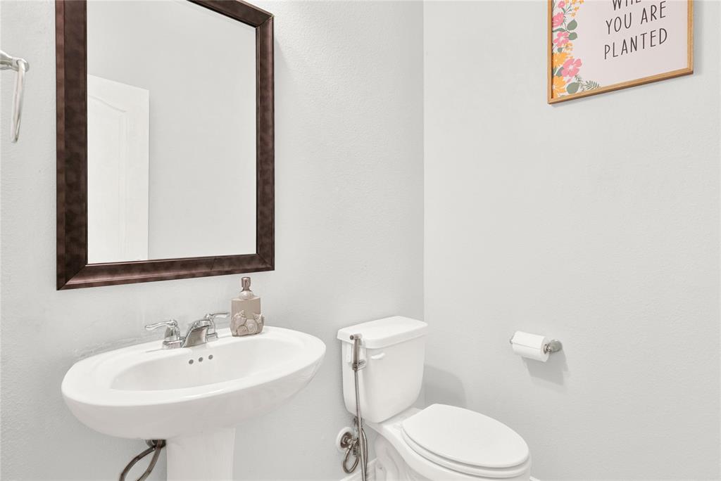 3712 Maroon Creek Road Aubrey, TX 76227 - Photo 10 of 21 a bathroom with a toilet sink and mirror