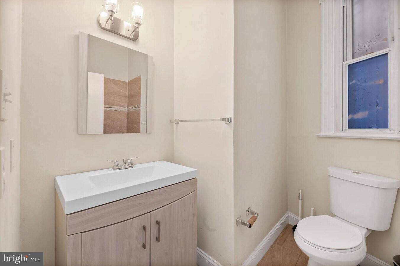 1821 North Capitol Street Northeast, Unit 2 Washington, DC 20002 - Photo 4 of 10 a bathroom with a sink a toilet and mirror