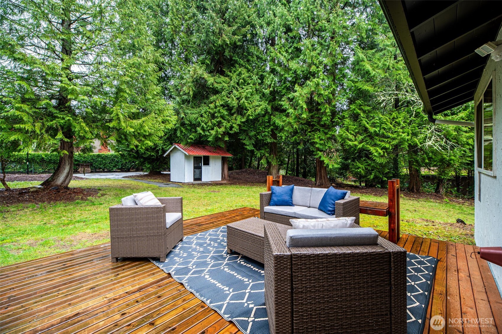 22629 57th Avenue Southeast Bothell, WA 98021 - Photo 34 of 40 a view of a patio with couches plants and large trees