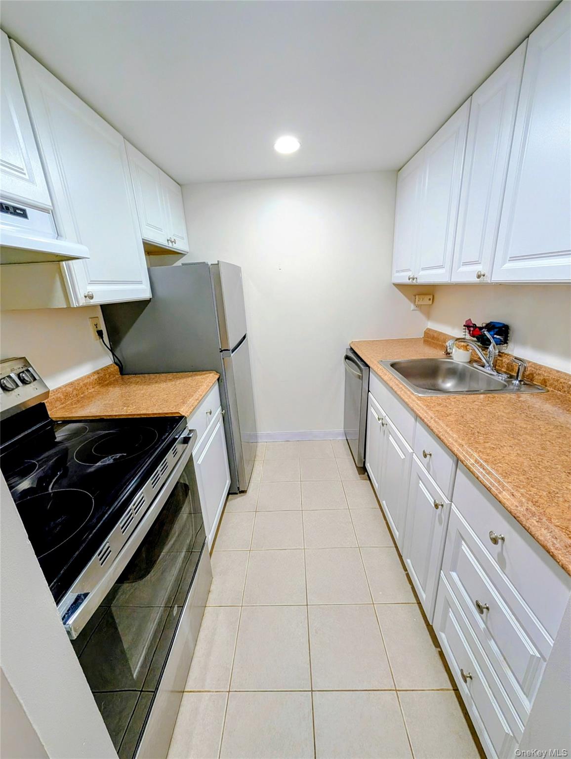150 Overlook Avenue, Unit 4L Peekskill, NY 10566 - Photo 13 of 32 a kitchen with a stove and a sink