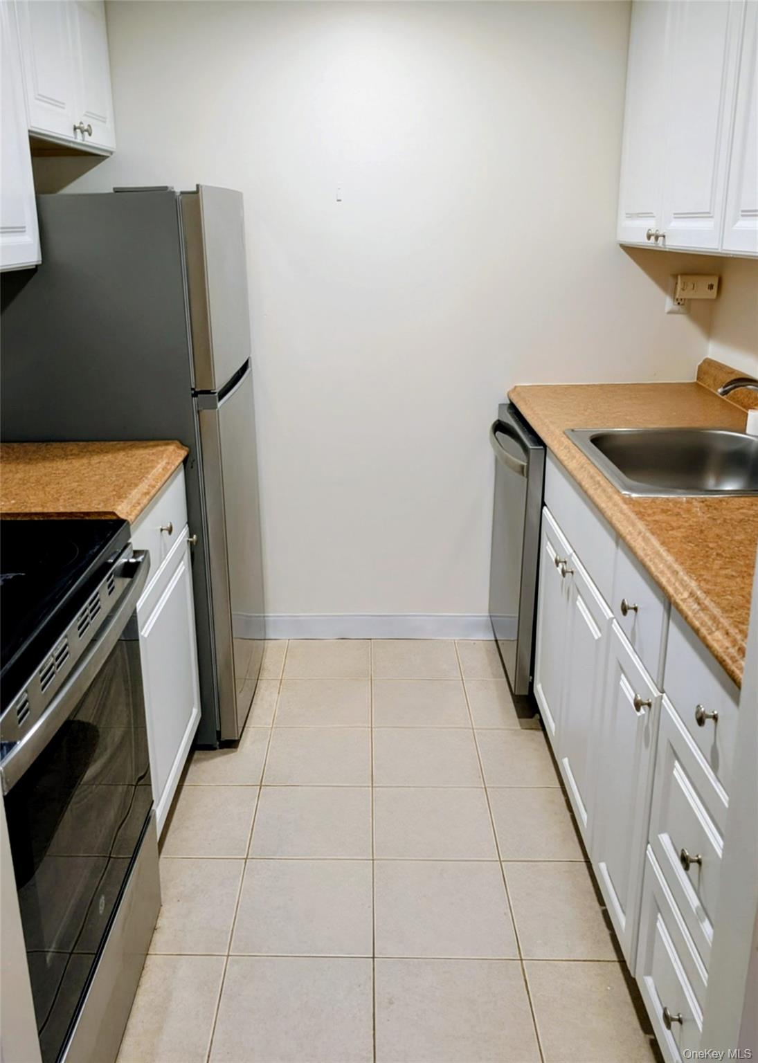 150 Overlook Avenue, Unit 4L Peekskill, NY 10566 - Photo 14 of 32 a kitchen with a sink stove and cabinets